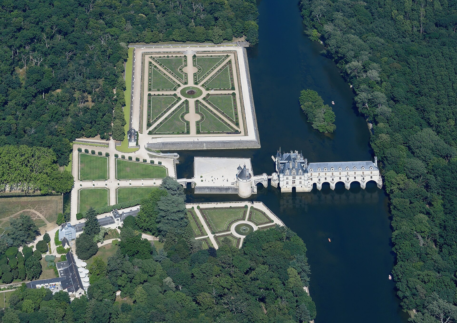 Aerial view showing Château de Chenonceau spanning the Cher between formal gardens and woodland