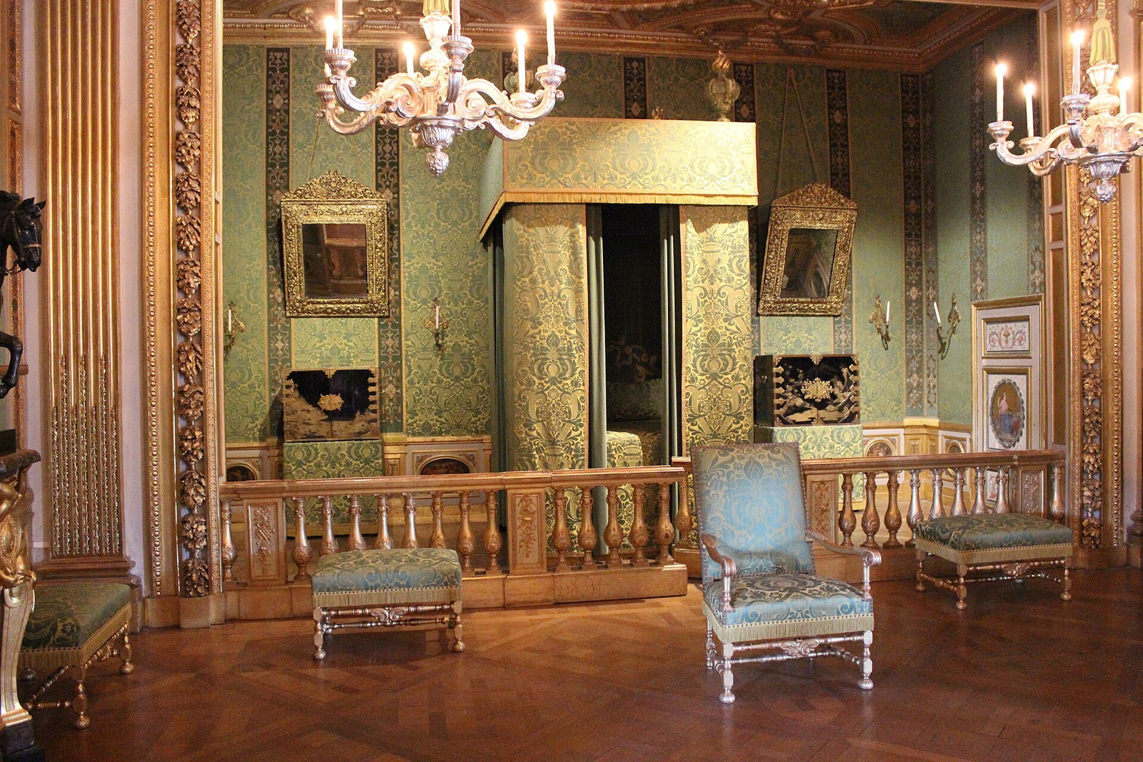 A mirrored reception room at Vaux-le-Vicomte with chandeliers and gilt details