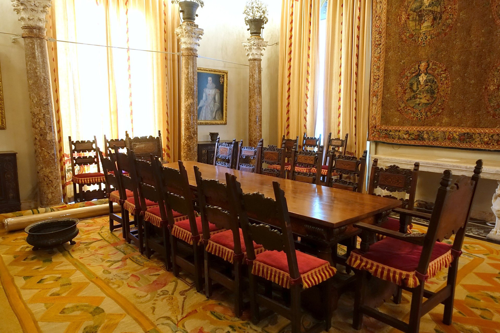 Vizcaya dining room with long table, tapestries, and carved architectural details