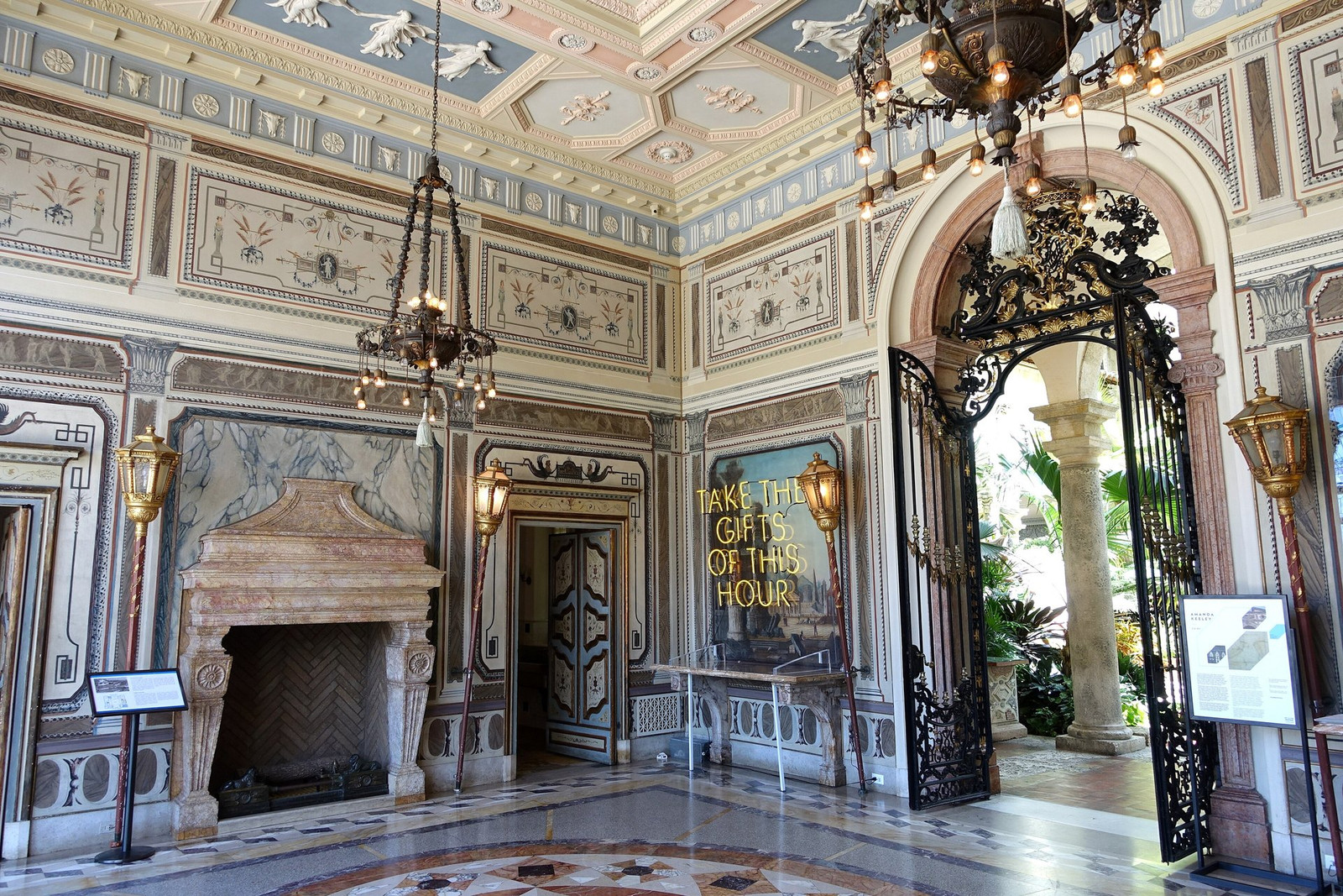 Vizcaya’s enclosed loggia with stone arches, painted ceiling, and fireplace