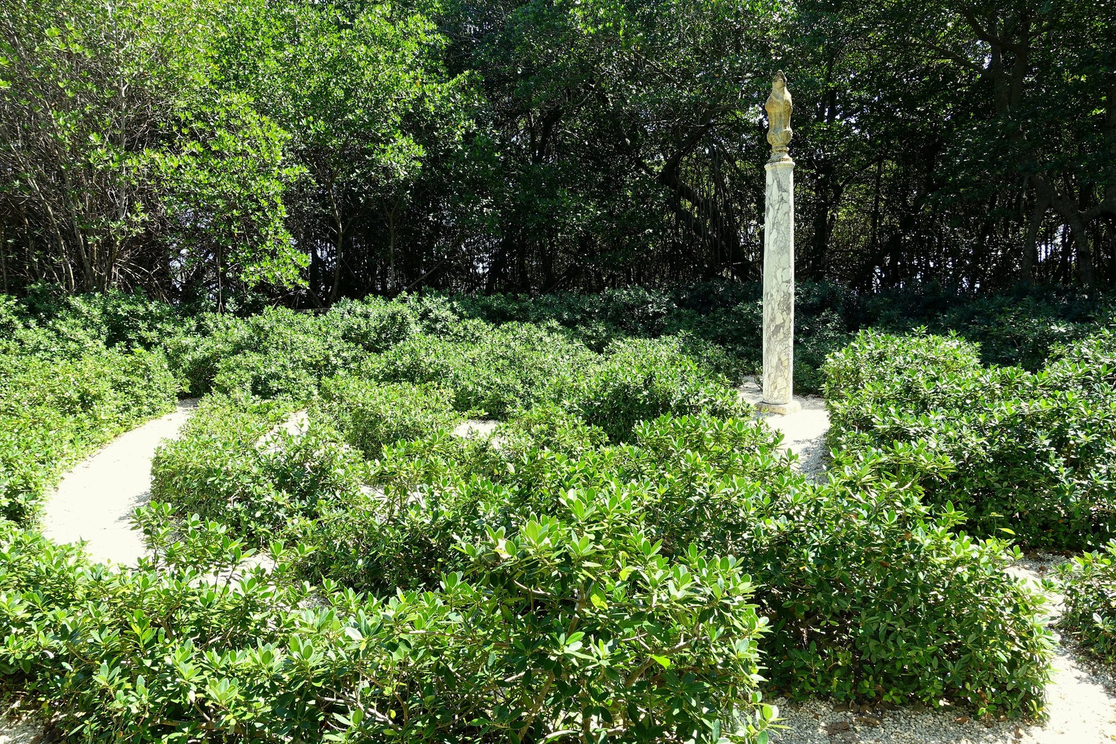 Vizcaya Maze Garden with clipped hedges, stone paths, and sculptural ornaments